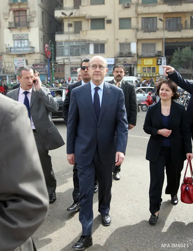 French newly appointed Foreign Minister Alain Juppe (C) walks on Cairo's Tahrir square on March 6, 2011 as part of a visit during which he affirmed his country's commitment to Egypt. Juppe, speaking to the French communi...