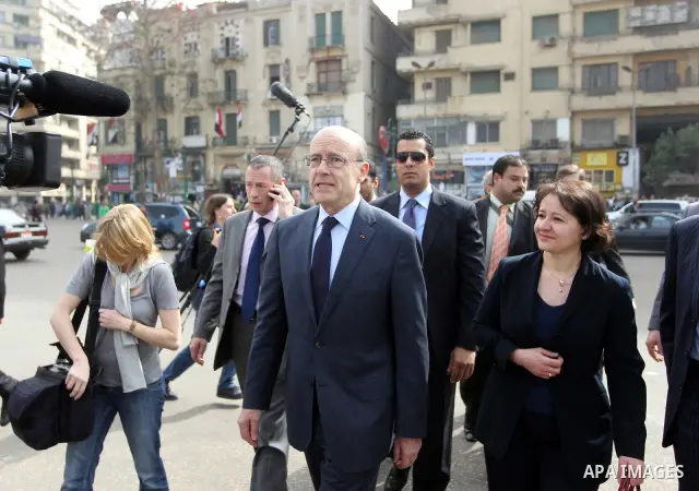 French newly appointed Foreign Minister Alain Juppe (C) walks on Cairo's Tahrir square on March 6, 2011 as part of a visit during which he affirmed his country's commitment to Egypt. Juppe, speaking to the French communi...