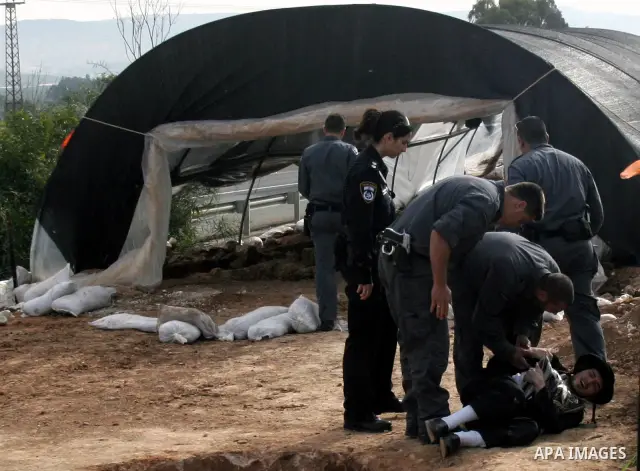 Israeli policeman arresting an ultra Orthodox during a protest against dig tombs in Haifa, on march 6, 2011. Photo by Mahfouz Abu Turk