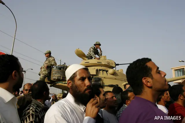 Egyptian protesters chant slogans during a demonstration in front of an Egyptian state security building in the outskirts of Cairo on Mach 5, 2011 while state security employees briefly fired gunshots as hundreds of prot...
