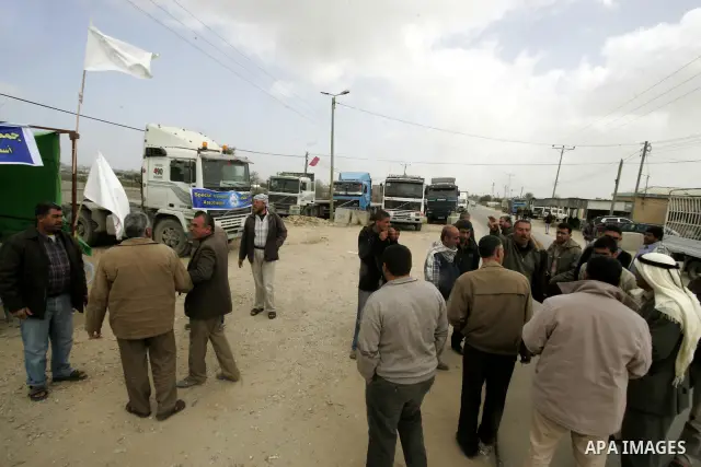 Palestinians stop with their lorries near the crossing of the Israeli crossing Kerem Shalom during a protest against the Israeli decision to close the Karni crossing, in the southern Gaza Strip on March 07, 2011. The own...