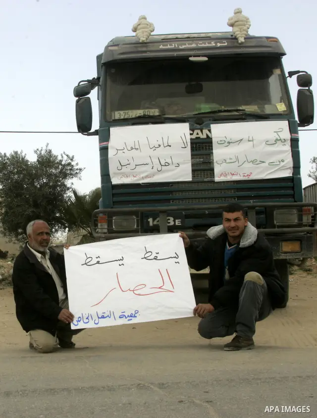 Palestinians stop with their lorries near the crossing of the Israeli crossing Kerem Shalom during a protest against the Israeli decision to close the Karni crossing, in the southern Gaza Strip on March 07, 2011. The own...