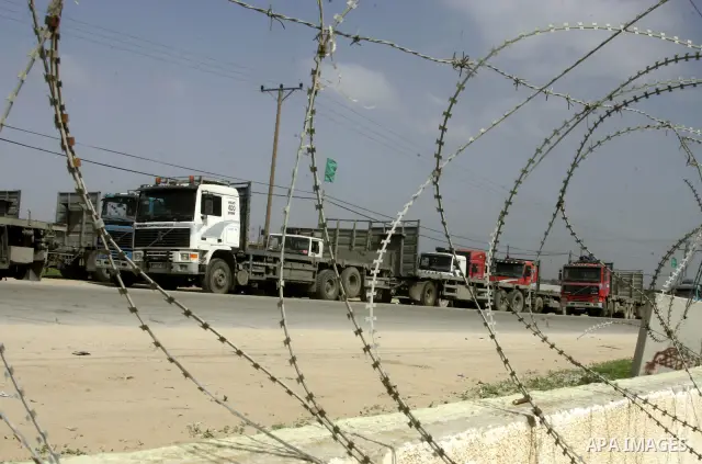 Palestinians stop with their lorries near the crossing of the Israeli crossing Kerem Shalom during a protest against the Israeli decision to close the Karni crossing, in the southern Gaza Strip on March 07, 2011. The own...