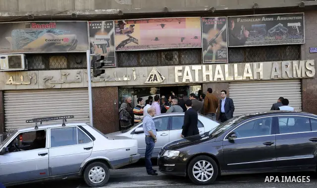 Egyptians gather in front of a shop for weapons in Cairo, Egypt, March 7, 2011. Photo by Ahmed Asad