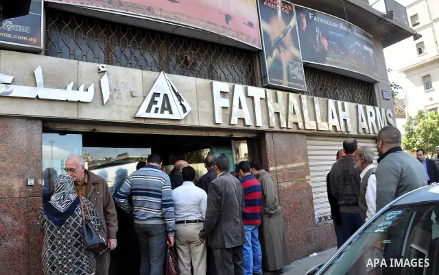 Egyptians gather in front of a shop for weapons in Cairo, Egypt, March 7, 2011. Photo by Ahmed Asad