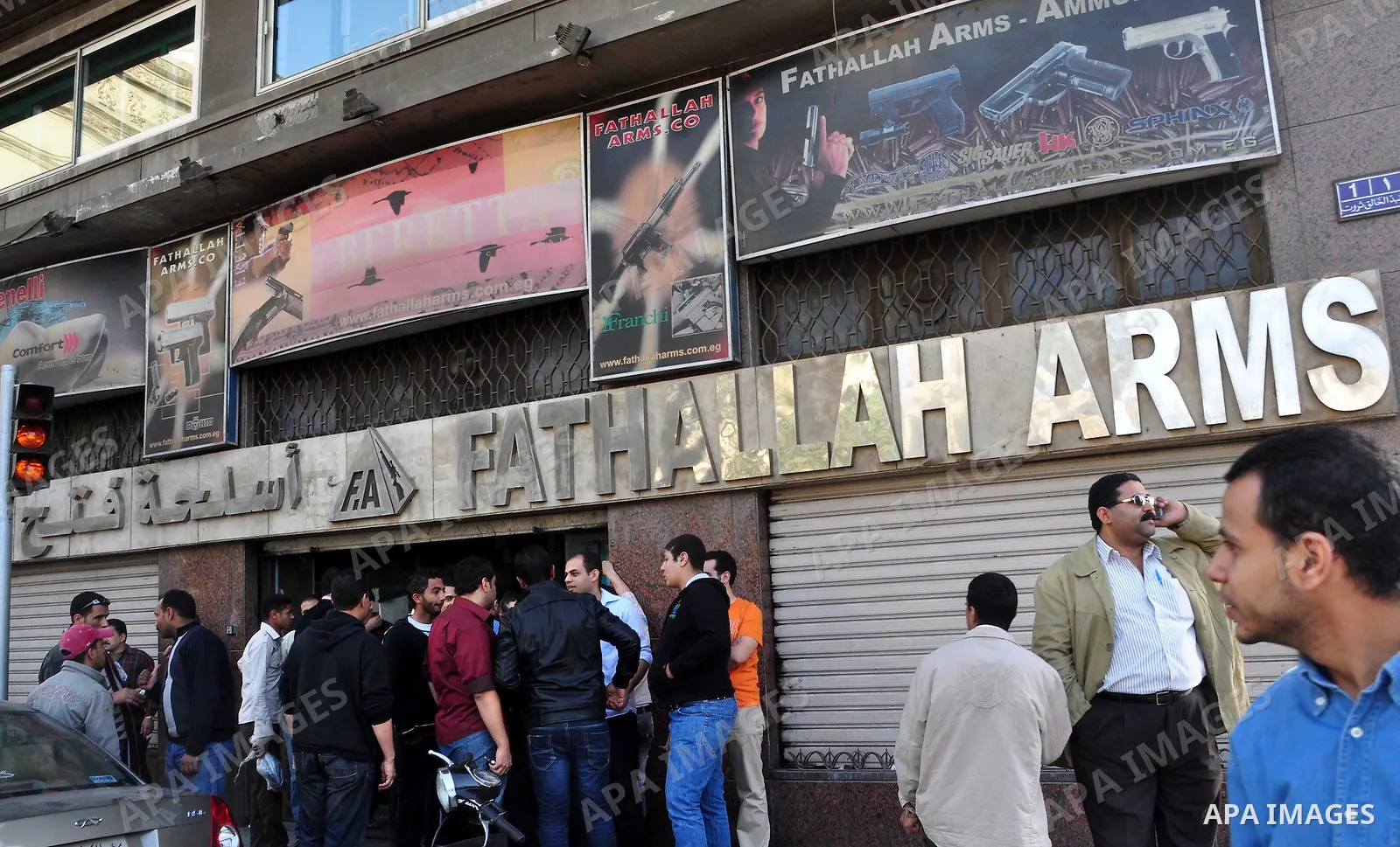 Egyptians gather in front of a shop for weapons in Cairo, Egypt, March 7, 2011. Photo by Ahmed Asad