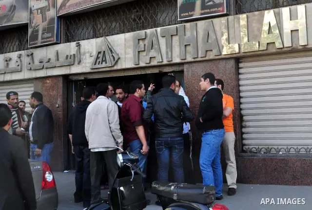 Egyptians gather in front of a shop for weapons in Cairo, Egypt, March 7, 2011. Photo by Ahmed Asad