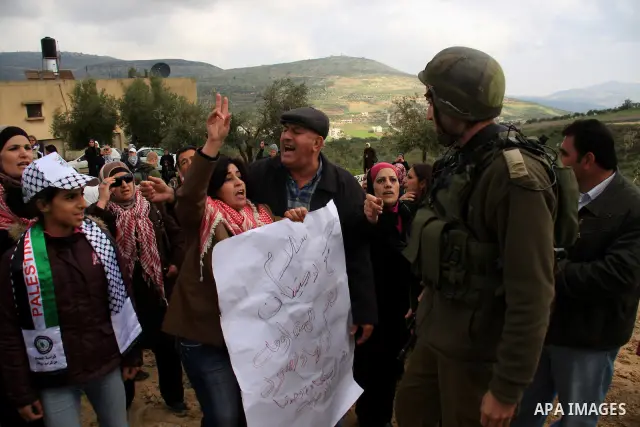 Palestinian women shout slogans during a women's demonstration in the West Bank village of Burin, near Nablus, Tuesday ,March 8, 2011. The protest was organized by Palestinian women to mark the International Women's Day...