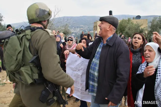 Palestinian women shout slogans during women's demonstration in the West Bank village of Burin, near Nablus, Tuesday ,March 8, 2011. The protest was organized by Palestinian women to mark the International Women's Day an...