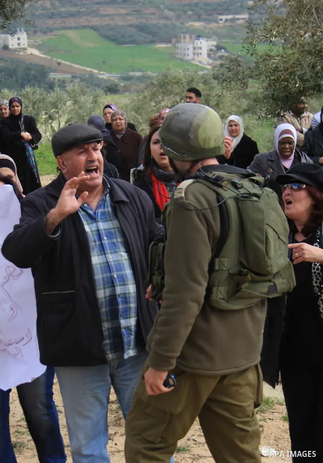 Palestinian women shout slogans during women's demonstration in the West Bank village of Burin, near Nablus, Tuesday ,March 8, 2011. The protest was organized by Palestinian women to mark the International Women's Day an...