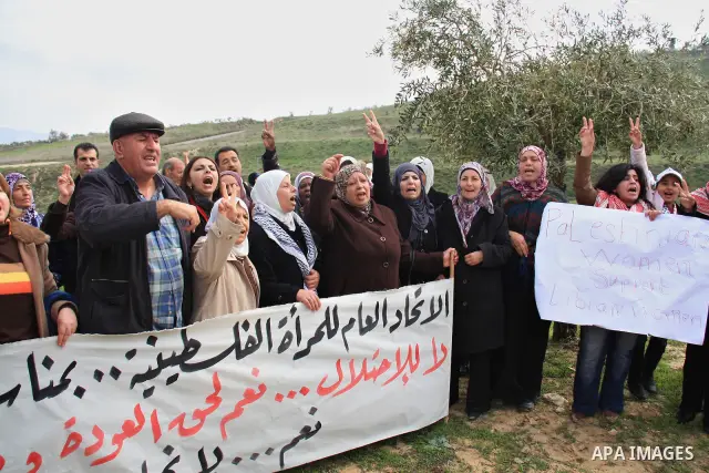 Palestinian women shout slogans during women's demonstration in the West Bank village of Burin, near Nablus, Tuesday ,March 8, 2011. The protest was organized by Palestinian women to mark the International Women's Day an...