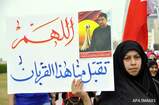 Bahraini anti-government women protesters wave flags and hold signs Tuesday, March 8, 2011, in Manama, Bahrain, to mark the International Woman Day. Photo by Ammar A.rasool