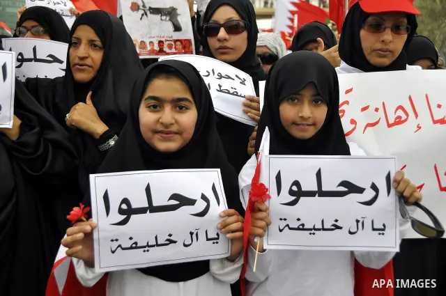 Bahraini anti-government women protesters wave flags and hold signs Tuesday, March 8, 2011, in Manama, Bahrain, to mark the International Woman Day. Photo by Ammar A.rasool