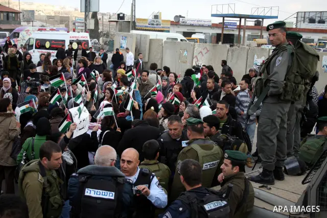 Palestinian women protest against the Israeli occupation of Palestinian territories on the occasion of women's day on March 8, 2011 at the Israeli-controlled Qalandia checkpoint, between Jerusalem and Ramallah. photo by:...