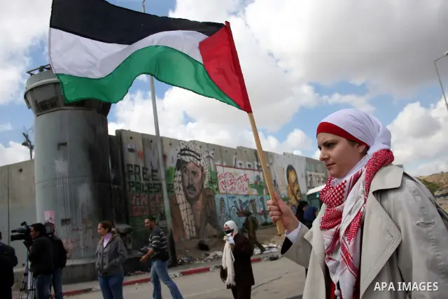 Palestinian women protest against the Israeli occupation of Palestinian territories on the occasion of women's day on March 8, 2011 at the Israeli-controlled Qalandia checkpoint, between Jerusalem and Ramallah. photo by:...