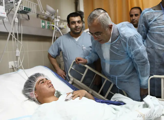 Palestinian Prime Minister Salam Fayyad pays a visit to Rafidya hospital in the West Bank city of Nablus on 08 March 2011, to meet some of the ten Palestinians wounded during the previous day clashes with Jewish settlers...