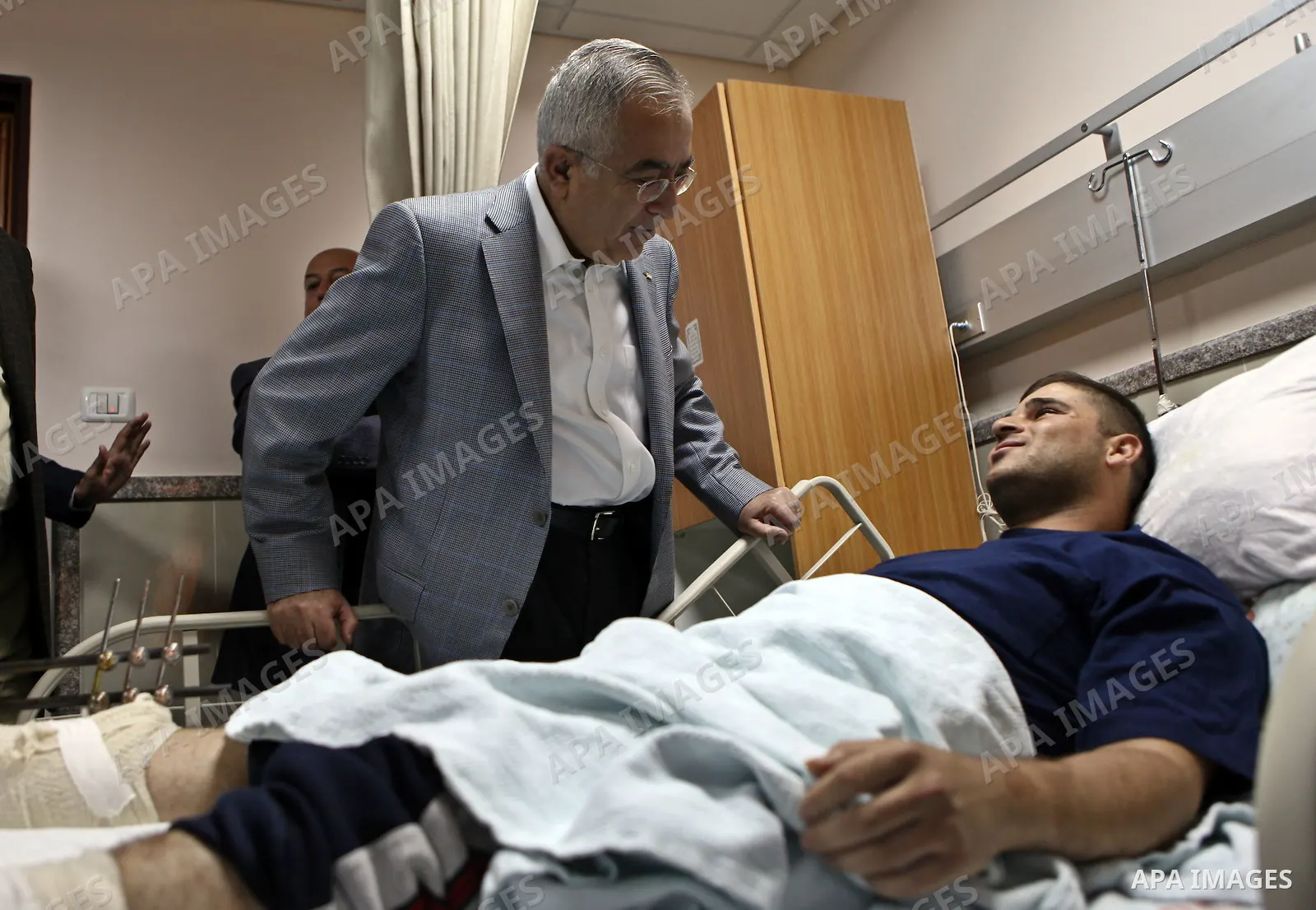 Palestinian Prime Minister Salam Fayyad pays a visit to Rafidya hospital in the West Bank city of Nablus on 08 March 2011, to meet some of the ten Palestinians wounded during the previous day clashes with Jewish settlers...