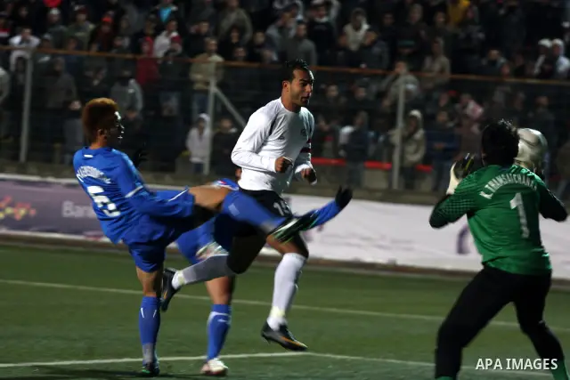 Palestinian (white) and Thailand national football players fight for the ball during their qualifier match for the Asian group of the 2012 London Olympics on March 9, 2011 at the Faisal Husseini stadium in the West Bank...