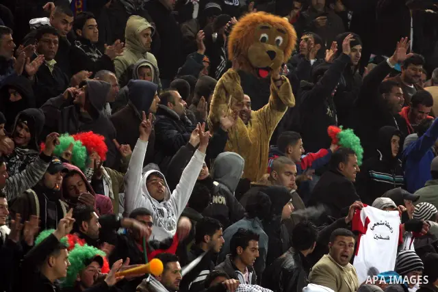 Palestinian fans watch their national football team play against Thailand during their qualifier for the Asian group of the 2012 London Olympics on March 9, 2011 at the Faisal Husseini stadium in the West Bank town of al...