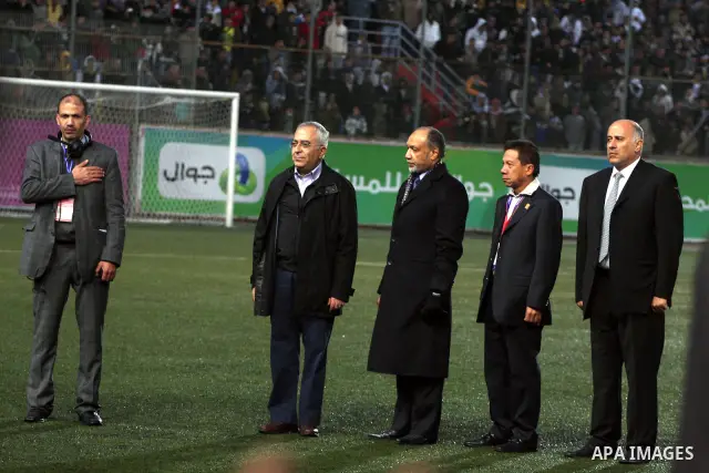 Palestinian prime minister Salam Fayyad participate with the national football team play against Thailand during their qualifier for the Asian group of the 2012 London Olympics on March 9, 2011 at the Faisal Husseini sta...
