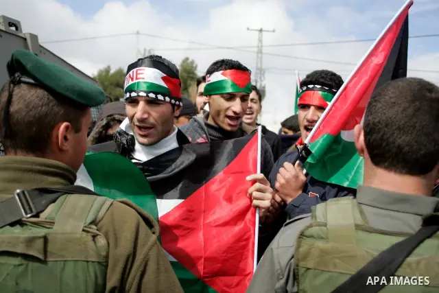 Protesters argue with Israeli soldiers during a demonstration against Israel's controversial separation barrier in the West Bank village of Maasarah, near the biblical town of Bethlehem on March 11, 2011.Israel says the...