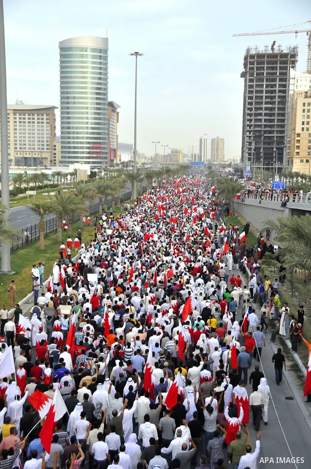 Thousands of Bahraini anti-government demonstrators chant slogans against the king on March 11, 2011 as they march toward the royal palace in Manama where a group of pro-regime loyalists waited with clubs, swords and met...