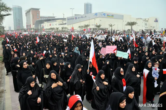 Thousands of Bahraini anti-government demonstrators chant slogans against the king on March 11, 2011 as they march toward the royal palace in Manama where a group of pro-regime loyalists waited with clubs, swords and met...