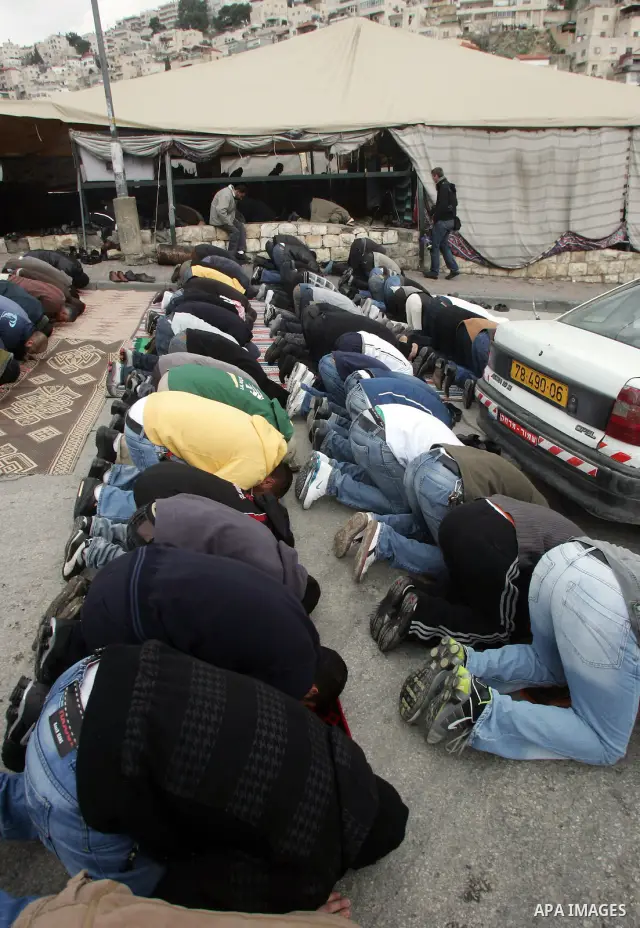 Palestinians attend Friday prayers at a protest tent in east Jerusalem of Silwan on March 11, 2011. Photo by Mahfouz Abu Turk