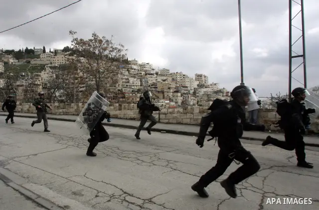 Israeli security officer shot a tear gas canister towards Palestinian stone-throwers, not pictured, during clashes in the east Jerusalem neighborhood of Silwan, Friday, March 11, 2011. Photo by Mahfouz Abu Turk