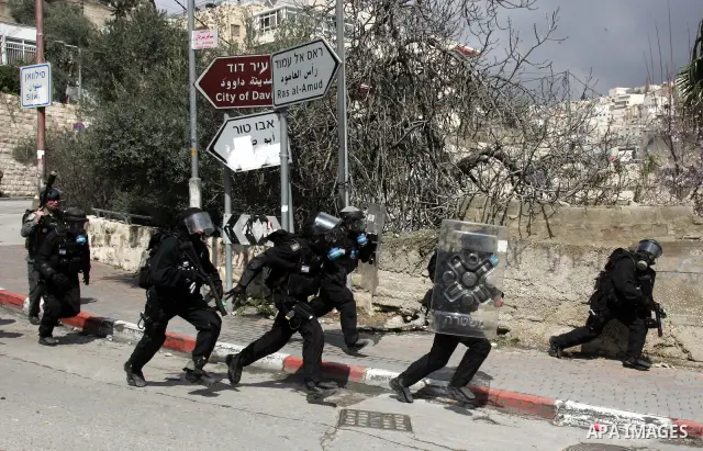 Israeli security officer shot a tear gas canister towards Palestinian stone-throwers, not pictured, during clashes in the east Jerusalem neighborhood of Silwan, Friday, March 11, 2011. Photo by Mahfouz Abu Turk
