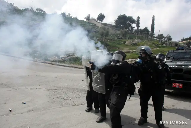 Israeli security officer shot a tear gas canister towards Palestinian stone-throwers, not pictured, during clashes in the east Jerusalem neighborhood of Silwan, Friday, March 11, 2011. Photo by Mahfouz Abu Turk