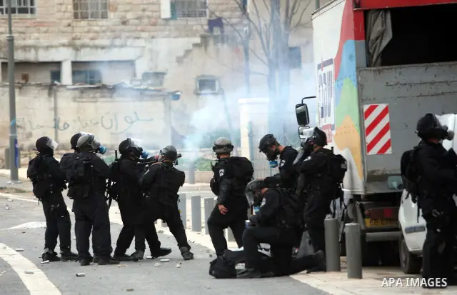 Israeli security officer shots a tear gas canister towards Palestinian stone-throwers, not pictured, during clashes in the east Jerusalem neighborhood of Silwan, Friday, March 11, 2011. Photo by Sliman Khader