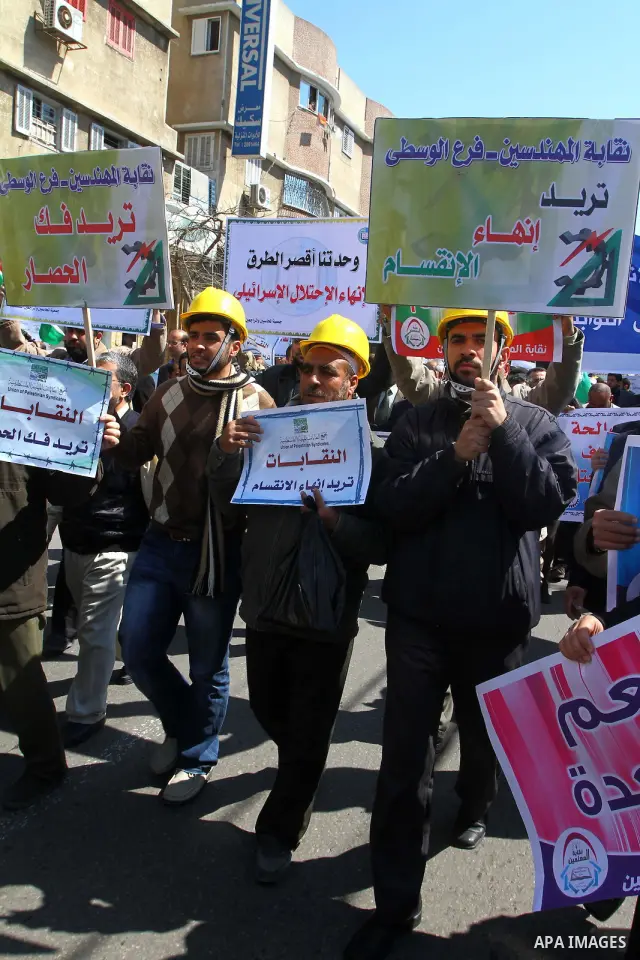 Palestinians hold signs during a protest calling for a national reconciliation between the tow parties Fatah and Hamas in Gaza City on March 12, 2011. Photo by Ashraf Amra