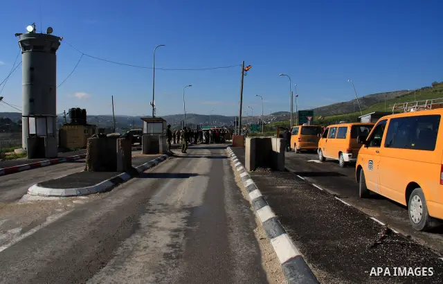 Israeli soldiers check identity cards of Palestinians at a military checkpoint of Hawara near the West Bank city of Nablus on March 12, 2011. The Israeli army announced the Palestinian city as closed military zone follow...