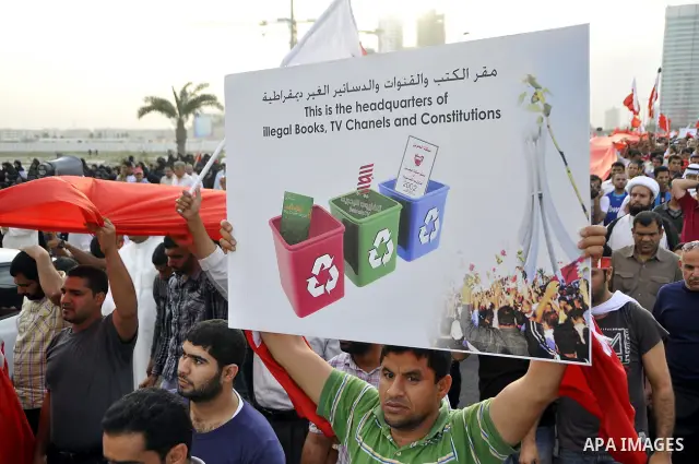Thousands of Bahraini anti-government demonstrators chant slogans against the king on March 11, 2011 as they march toward the royal palace in Manama where a group of pro-regime loyalists waited with clubs, swords and met...