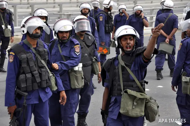 Bahraini anti-government protesters demonstrate in front of riot police on an overpass near Pearl roundabout Sunday, March 13, 2011, in Manama, Bahrain. Photo by Ammar A.rasool