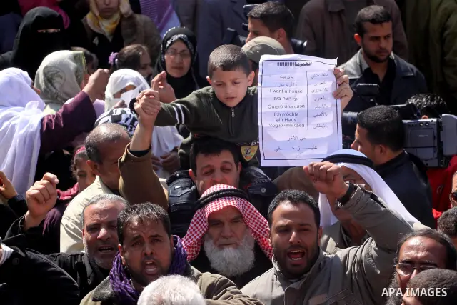 Palestinian lost their homes during the Israeli war in 2008-2009 attend a gathering calling for ending the siege in front of the United Nations Relief and Works Agency (UNRWA) headquarters in Gaza City March 13,2011. Pho...