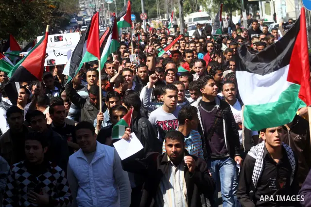 Palestinians participate in a march calling for a reconciliation between the rival Palestinian leading factions Hamas in Gaza and Fatah in the West Bank, in Gaza City, Monday, March 14, 2011. Photo by Ashraf Amra