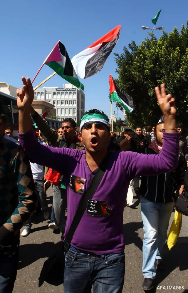 Palestinians participate in a march calling for a reconciliation between the rival Palestinian leading factions Hamas in Gaza and Fatah in the West Bank, in Gaza City, Monday, March 14, 2011. Photo by Ashraf Amra