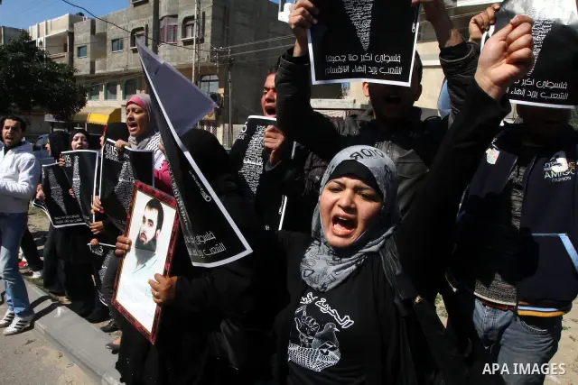 Palestinians participate in a march calling for a reconciliation between the rival Palestinian leading factions Hamas in Gaza and Fatah in the West Bank, in Gaza City, Monday, March 14, 2011. Photo by Ashraf Amra