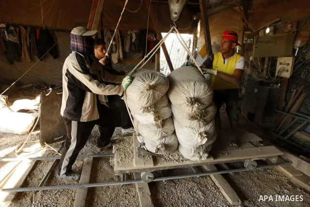 Palestinian men smuggle cement into the Gaza Strip through a tunnel under the Egypt-Gaza border in Rafah on March 14, 2011. Israel's blockade of the Gaza Strip was imposed after the militant Hamas group violently seized...