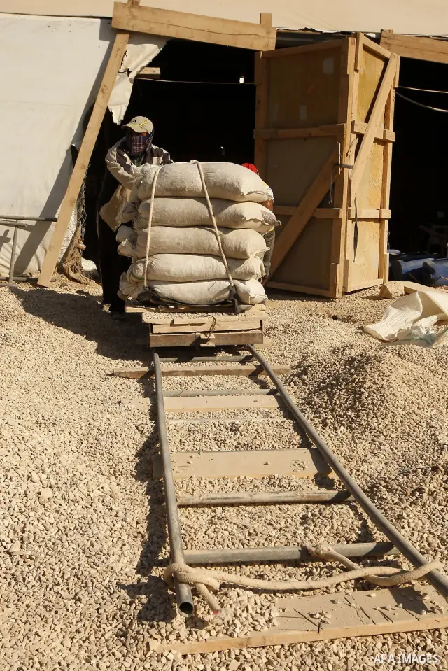Palestinian men smuggle cement into the Gaza Strip through a tunnel under the Egypt-Gaza border in Rafah on March 14, 2011. Israel's blockade of the Gaza Strip was imposed after the militant Hamas group violently seized...