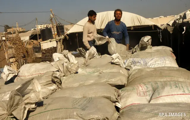 Palestinian men smuggle cement into the Gaza Strip through a tunnel under the Egypt-Gaza border in Rafah on March 14, 2011. Israel's blockade of the Gaza Strip was imposed after the militant Hamas group violently seized...