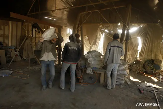 Palestinian men smuggle cement into the Gaza Strip through a tunnel under the Egypt-Gaza border in Rafah on March 14, 2011. Israel's blockade of the Gaza Strip was imposed after the militant Hamas group violently seized...