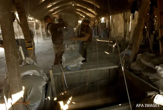 Palestinian men smuggle cement into the Gaza Strip through a tunnel under the Egypt-Gaza border in Rafah on March 14, 2011. Israel's blockade of the Gaza Strip was imposed after the militant Hamas group violently seized...