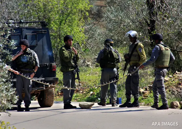 Israeli soldiers set up a temporary checkpoint during a military operation the West Bank village of Awarta, near Nablus, Monday, March 14, 2011. The U.S. Embassy said Monday it was "deeply concerned" by Israel's plans to...