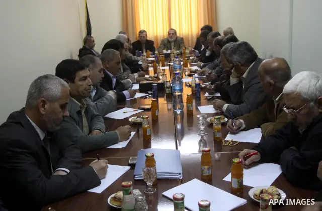 Palestinian factions leaders attend a meeting to discuss the protests calling for a reconciliation between the rival Palestinian leading factions Hamas in Gaza and Fatah in the West Bank, in Gaza City, Monday, March 14,...