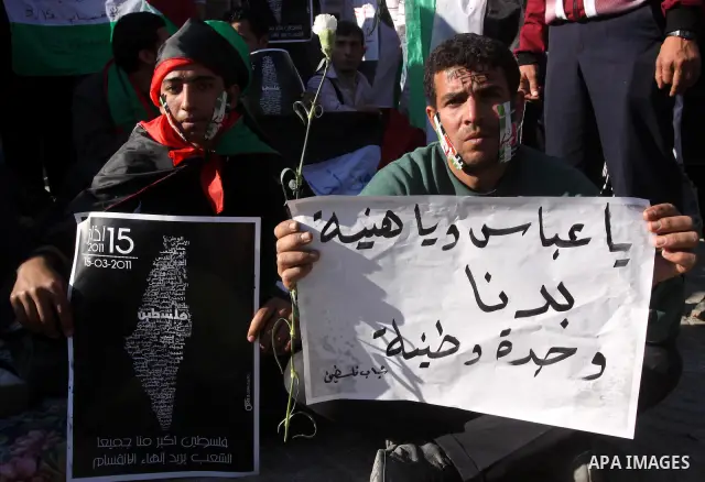 Palestinians participate in a march calling for a reconciliation between the rival Palestinian leading factions Hamas in Gaza and Fatah in the West Bank, in Gaza City, Monday, March 14, 2011. Photo by Mohammed Asad