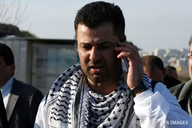 Palestinian activist Abdullah Abu Rahma , 39, the coordinator of the Popular Committee against the Wall and Settlements in Bilin, speaks on the phone after his release from Israel's Ofer prison following 16 months in jai...