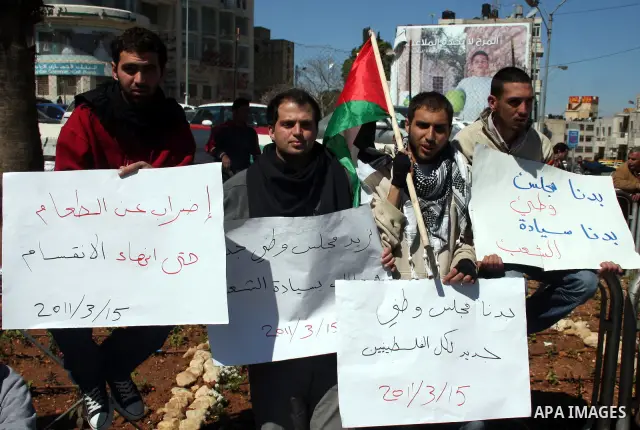 Palestinians participate in a march calling for a reconciliation between the rival Palestinian leading factions Hamas in Gaza and Fatah in the West Bank, in Ramallah, Monday, March 14, 2011. Photo by Issam Rimawi
